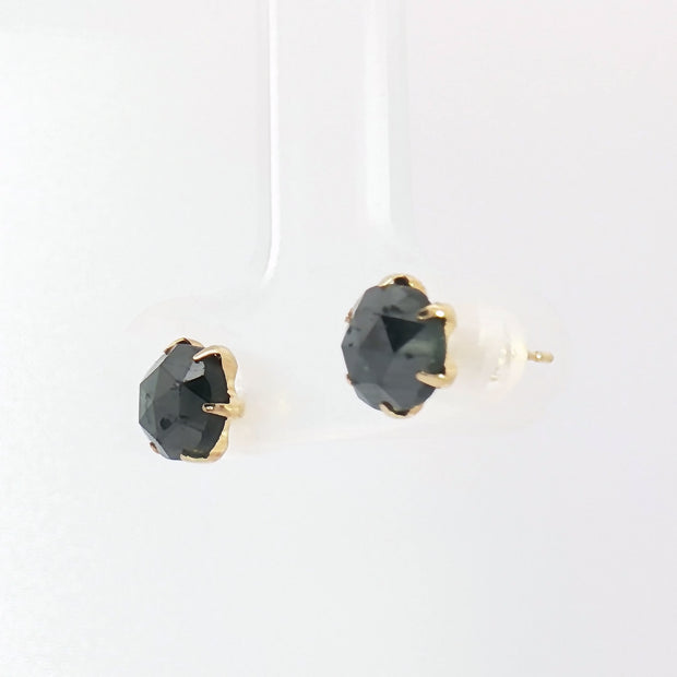 Close-up of 2.40ct fancy black diamond stud earrings in yellow gold