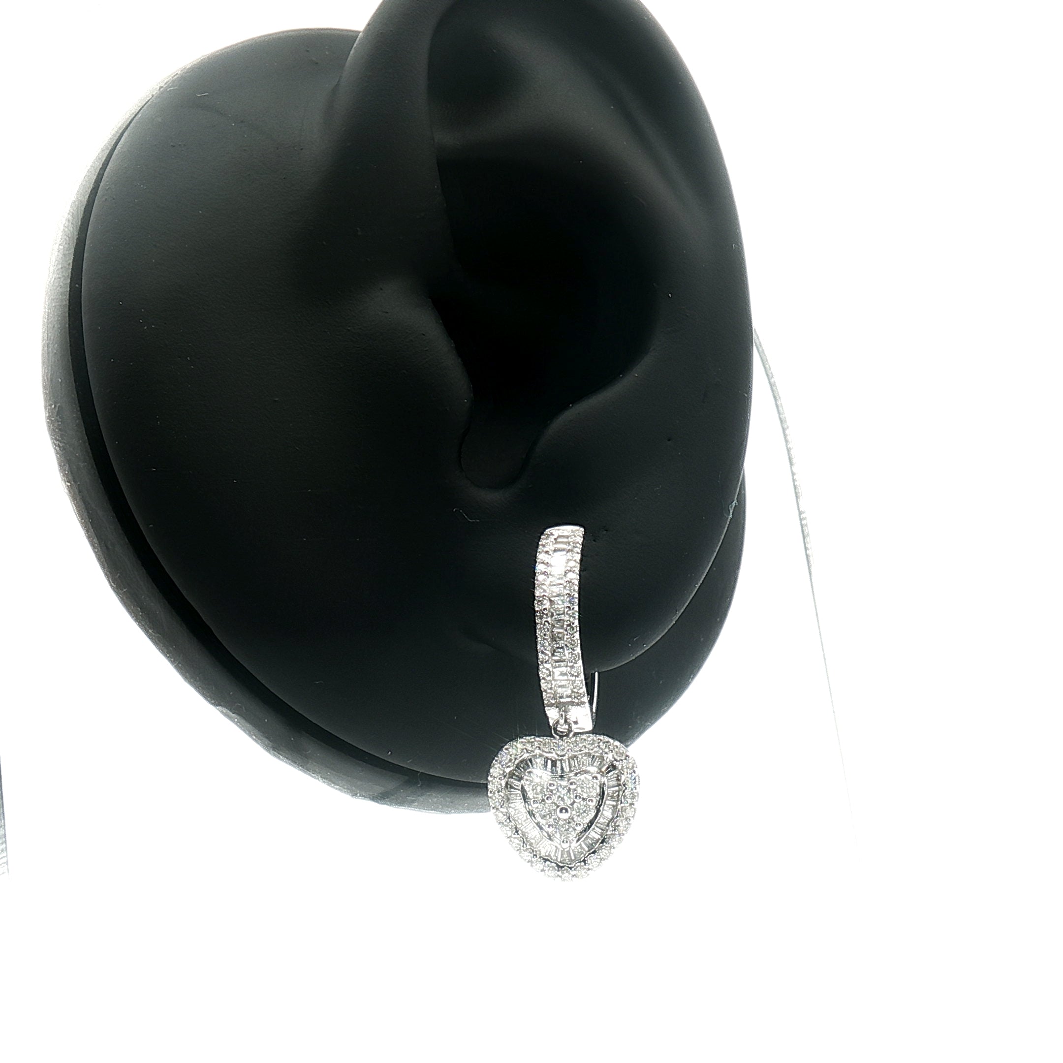 Macro detail of heart-shaped diamond settings in white gold dangle earrings