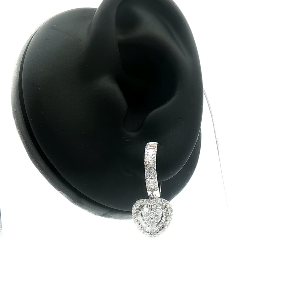 Macro detail of heart-shaped diamond settings in white gold dangle earrings