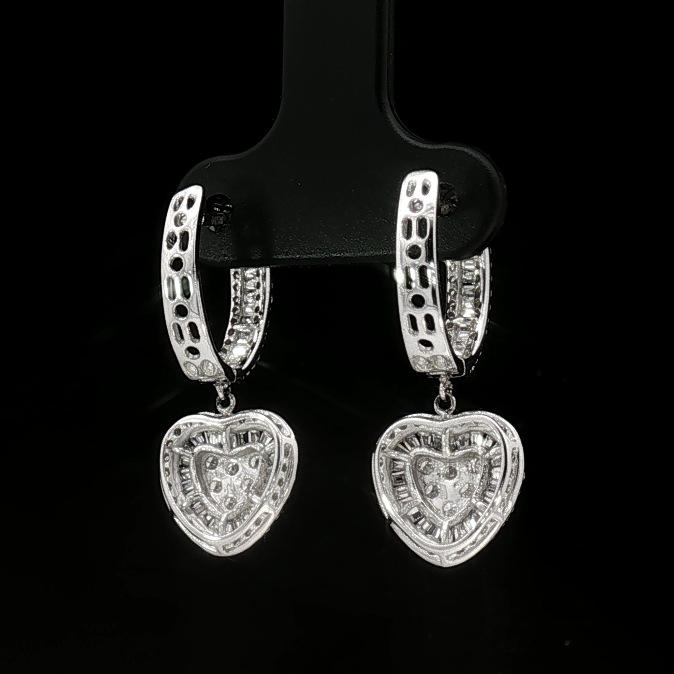 Pair of 18k white gold heart-shaped diamond earrings with sparkling natural stones
